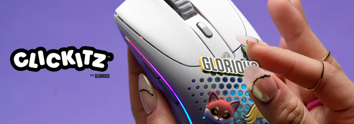 Hand holding a white Model O 2 wireless mouse with Glorious Switch character charms inserted into it