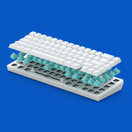 A White GMMK 2 65% Barebones with GPBT Arctic White Keycaps is shown in an exploded view, revealing Glorious Lynx switches beneath the keys. The background is a vibrant blue.