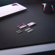 GMMK 2 Replacement Kit feet in pink on a black mousepad
