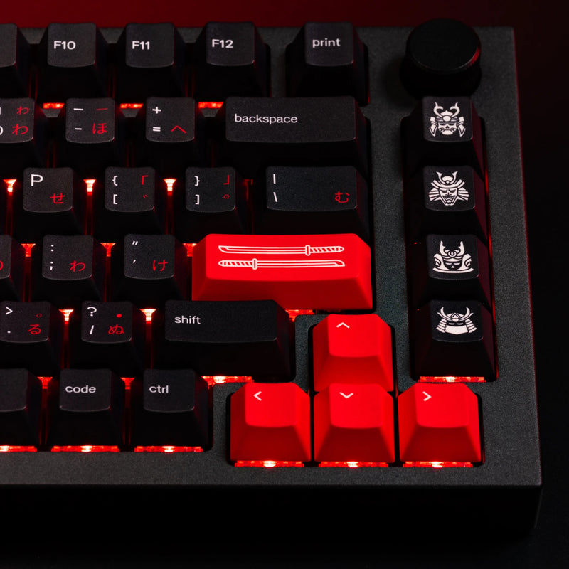 Close up of novelty keys from the GPBT Kabuto keycap set, featuring red samurai swords and samurai mask keys