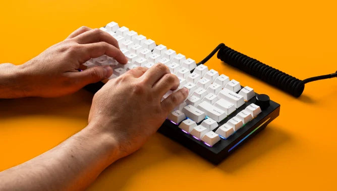 hands typing on a GMMK PRO Prebuilt keyboard